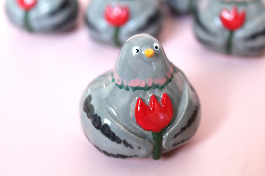 Pigeon holding flower