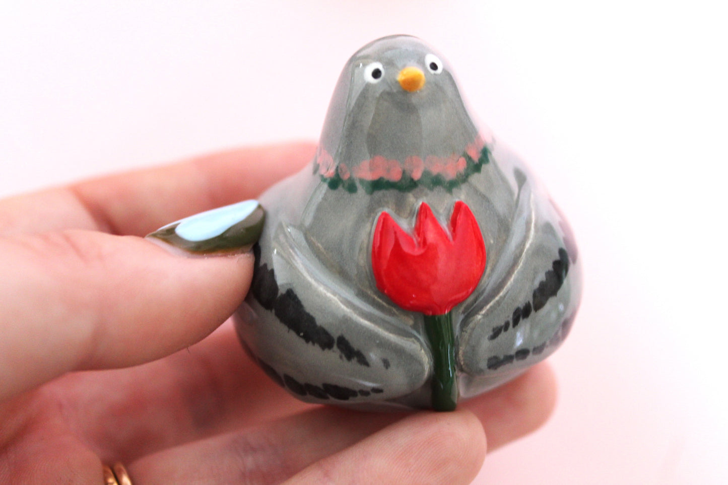 Pigeon holding flower